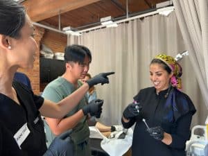 Medical aesthetics students practicing Botox injections in a Canadian training course
