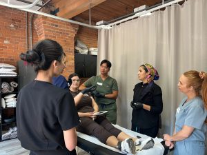 CAMA students receiving hands-on microneedling certification training