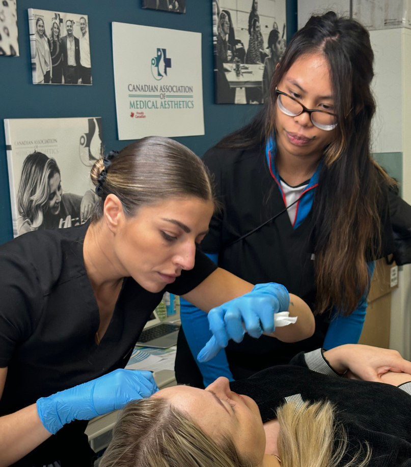 Nurse injector showing a CAMA student a treatment procedure during a Canadian Association of Medical Aesthetics training course