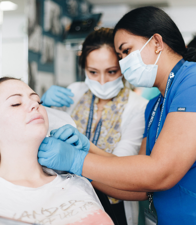 Aesthetician readying a mesotherapy injection for a patient during a medical aesthetics training course