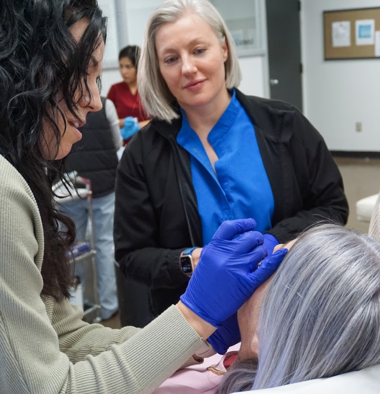 Nurse injector with the Canadian Association of Medical Aesthetics performing a treatment on a patient with a faculty member observing