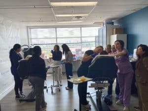 Medical aesthetics students practicing dermal filler injection during training